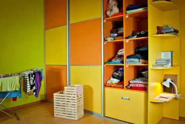 Organized custom closet system in a colorful kids’ bedroom