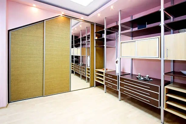 Small walk-in closet design with mirrors and light tones for spacious feel