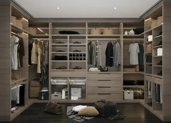 Completed custom closet system with hanging clothes and built-in drawers