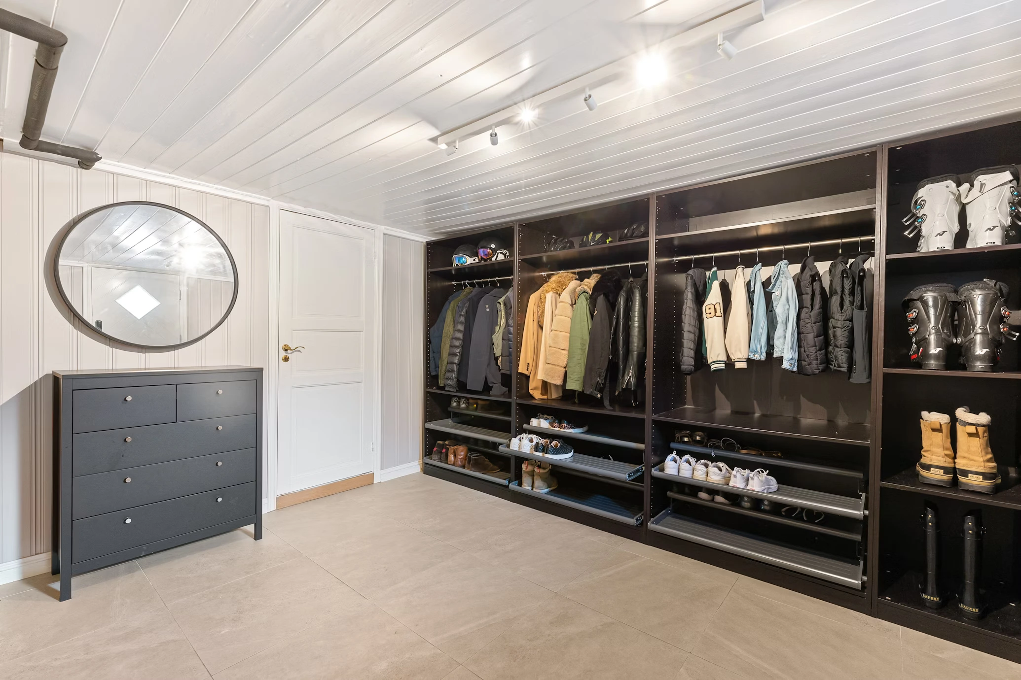Modern custom wardrobe closet with shelves, drawers, and accent lighting