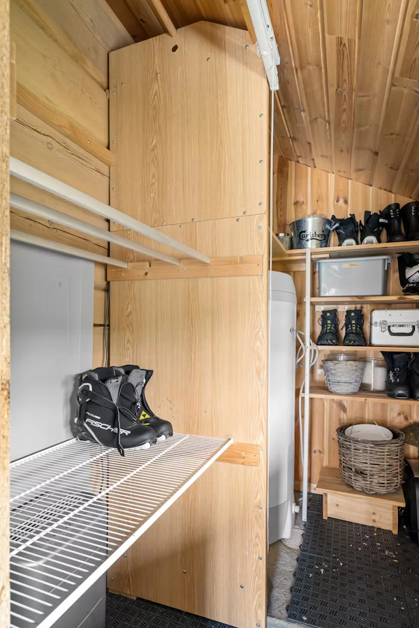 Custom garage storage system with cabinets, wall racks, and shelves.