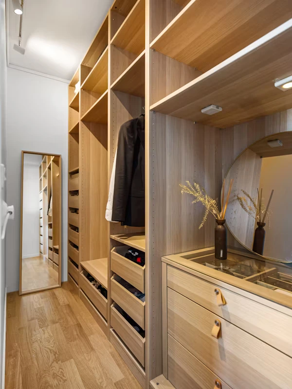 Small custom walk-in closet maximizing bedroom space with organized shelves and drawers
