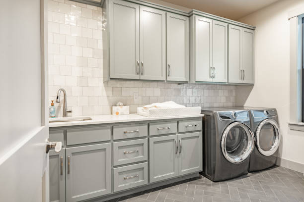  Bathroom powder room and laundry room all with light grey cabinets and warm wood tones.