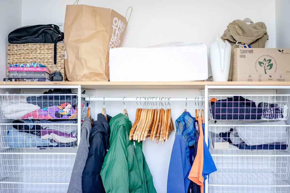 custom laundry room pull-out hamper system built into cabinetry for sorting