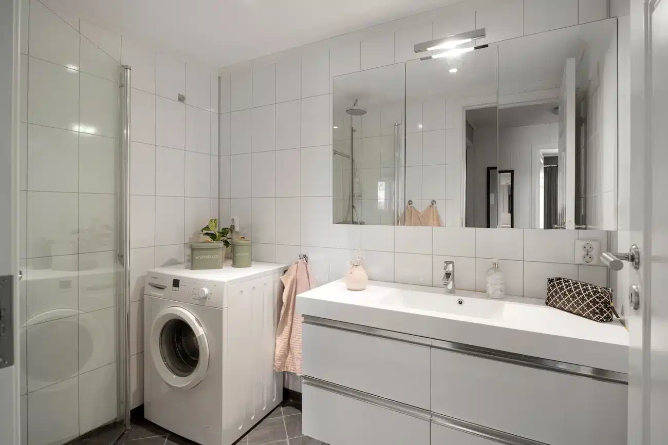 custom laundry room with utility sink integrated into white built-in cabinetry