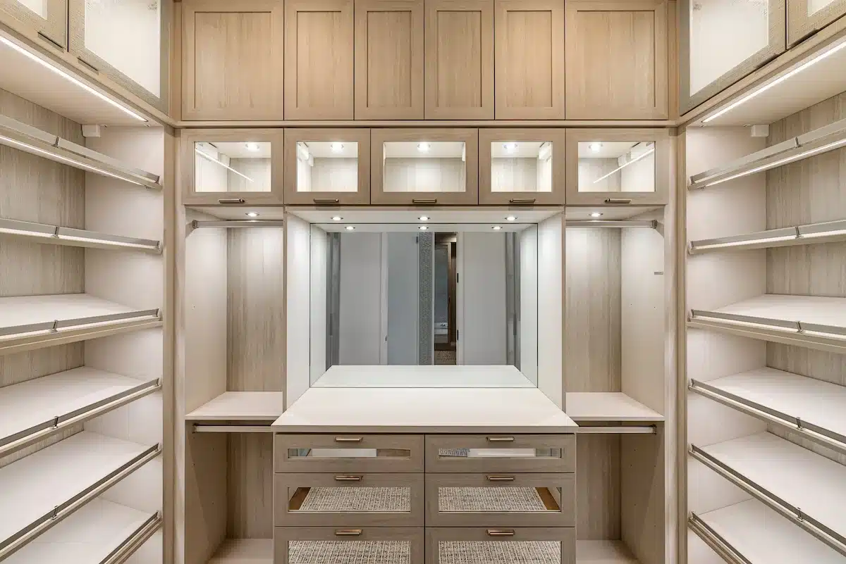walk-in master closets with integrated LED shelf lighting and warm boutique atmosphere